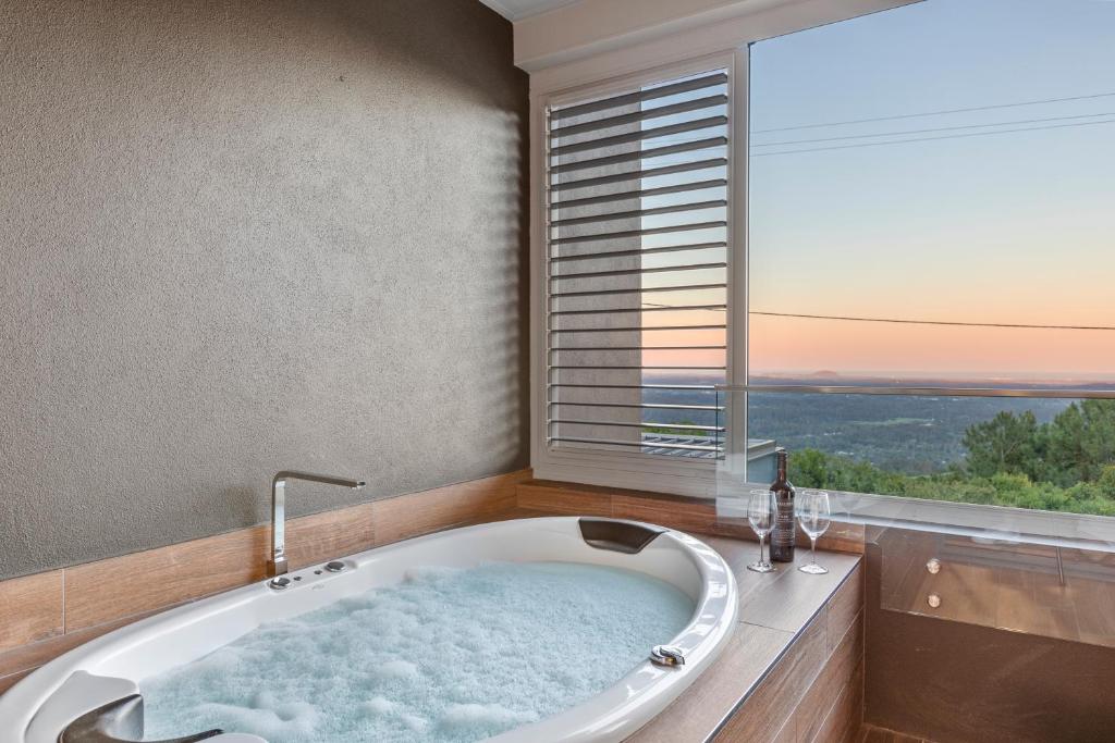 A spa bath overlooking a panoramic sunset view