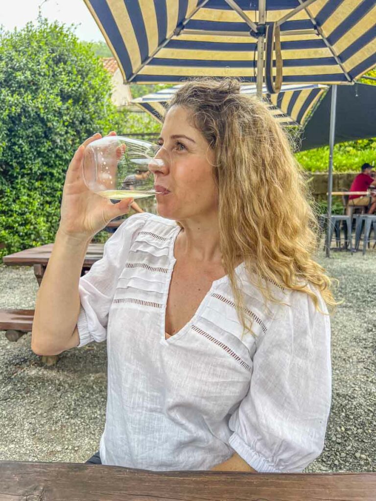 A women taking a sip of wine at Witches Falls Winery in Scenic Rim