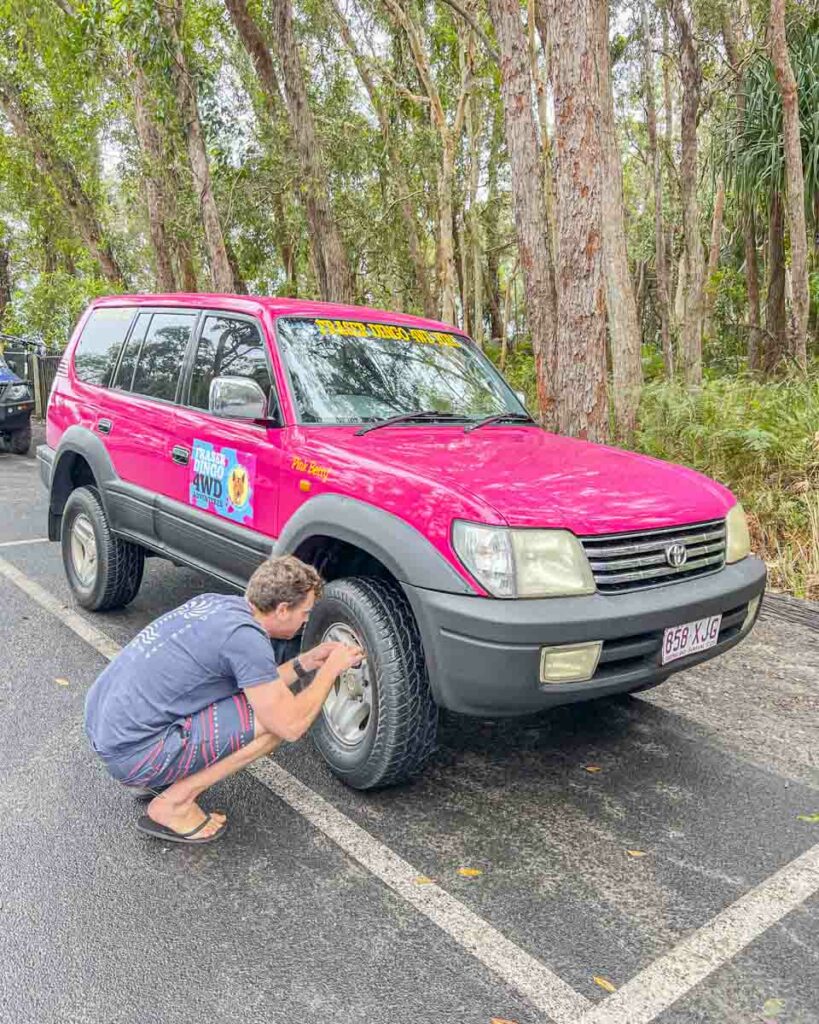 Gary deflating his Fraser Island 4WD rental tires